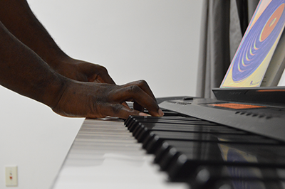 close up hands playing the piano